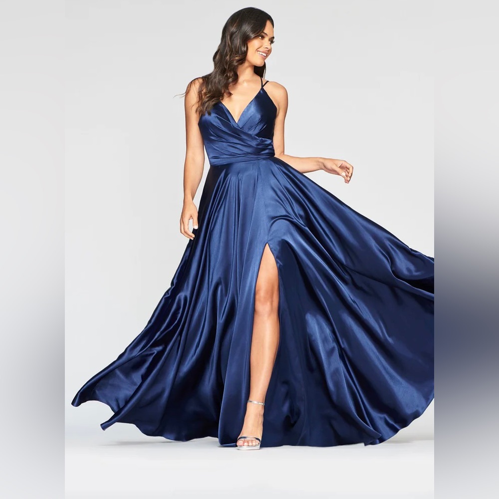 Long dark blue ball gown with full skirt and a slit.